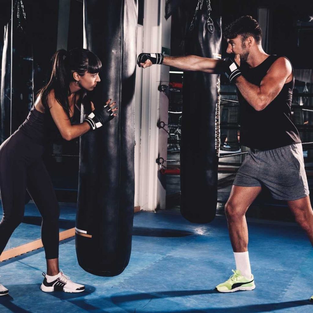 A man and a woman doing boxing exercise at fit club Amersham