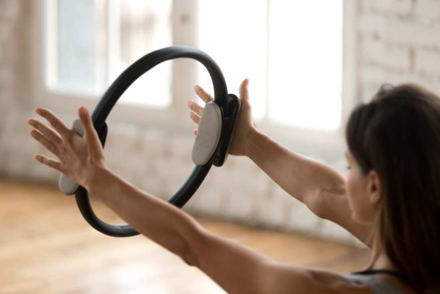 A woman reducing her stress level by doing pilates at Fit Club Amersham